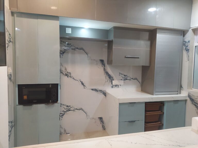 Kitchen with marble-look backsplash and wall cabinets