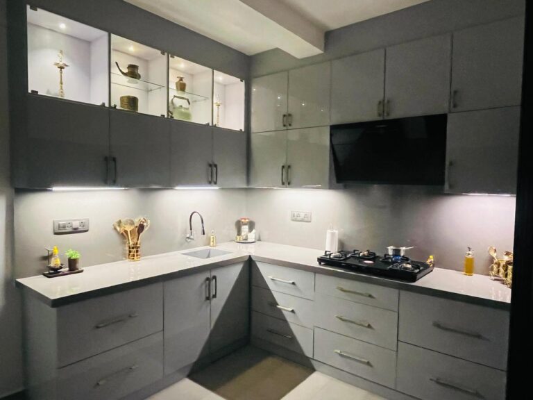 The same kitchen after renovation: fitted cabinets and stone counter